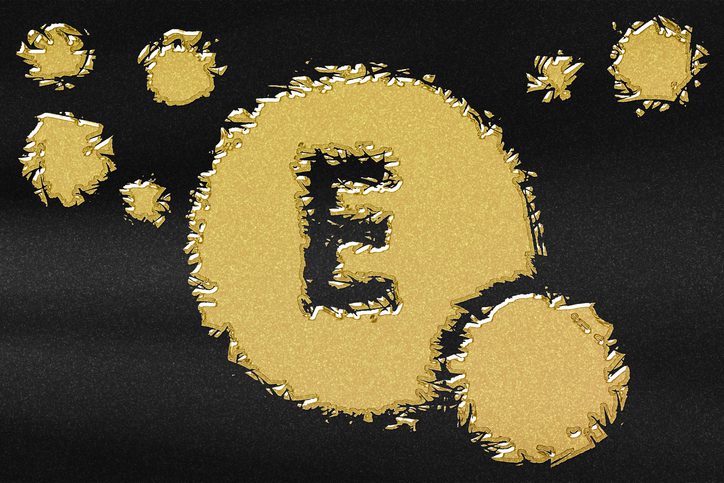 Vitamin E health Symbol, vitamin Concept, Tocopherols, Tocotrienols, antioxidant function, abstract gold with black background